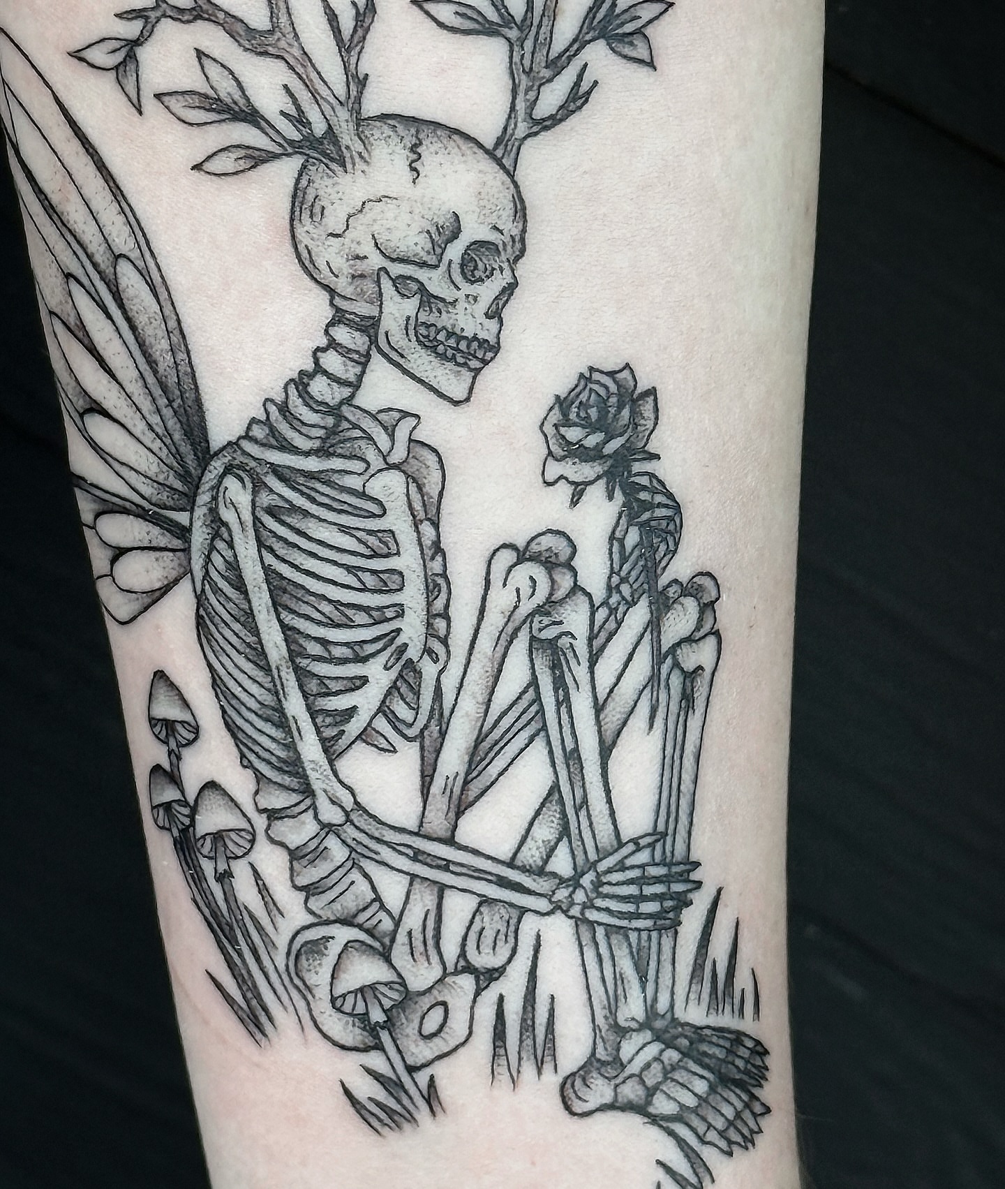 Skeleton with wings realism tattoo on the forearm by Breezy Tucker