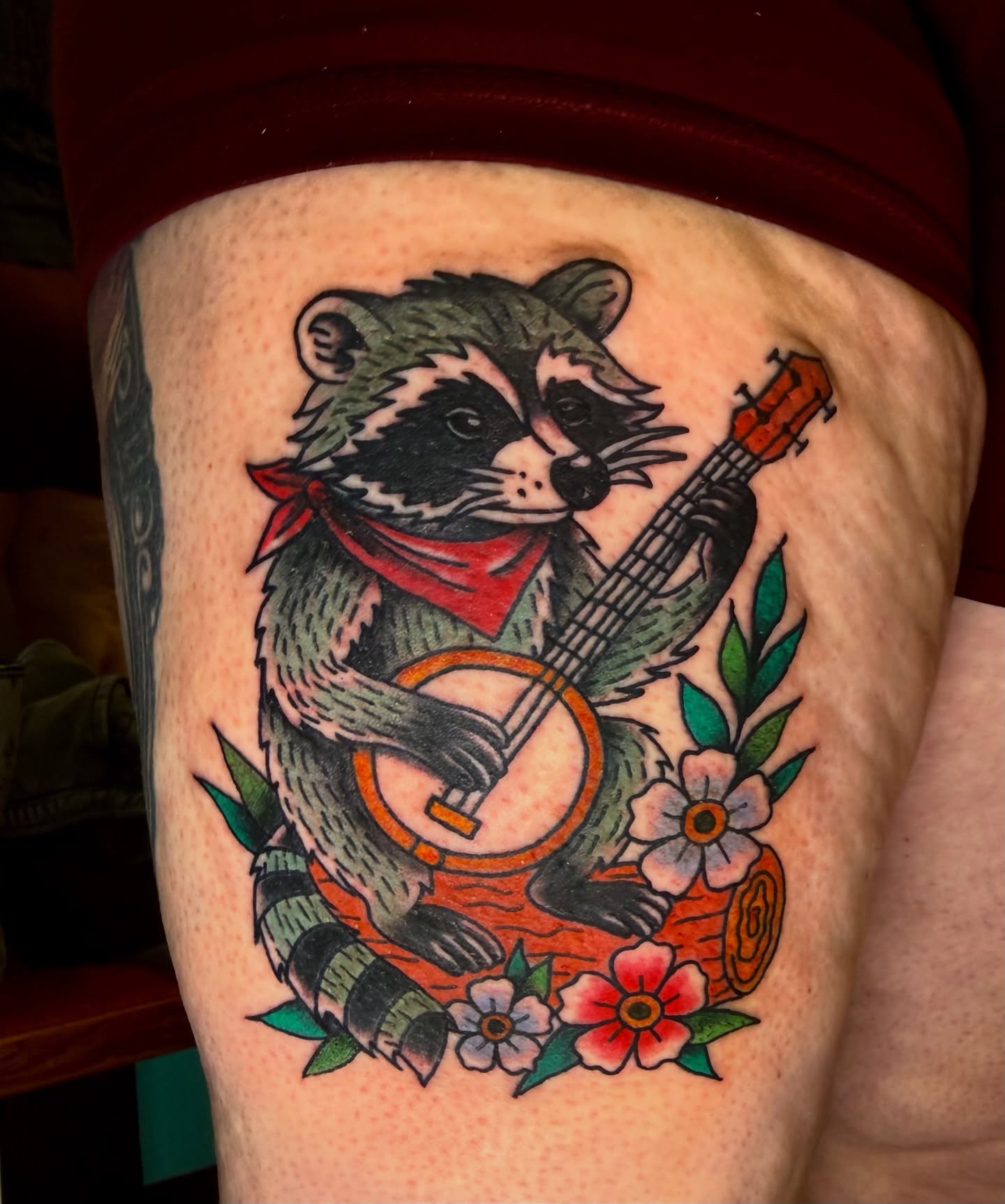 Raccoon playing banjo American traditional tattoo on the thigh by π Erin Stephens π€