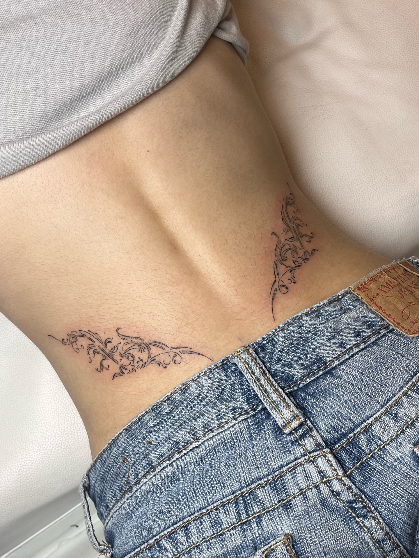 Scrollwork ornamental tattoo on the ribs by brinley - fine line tattoos, Crescent Springs, Kentucky