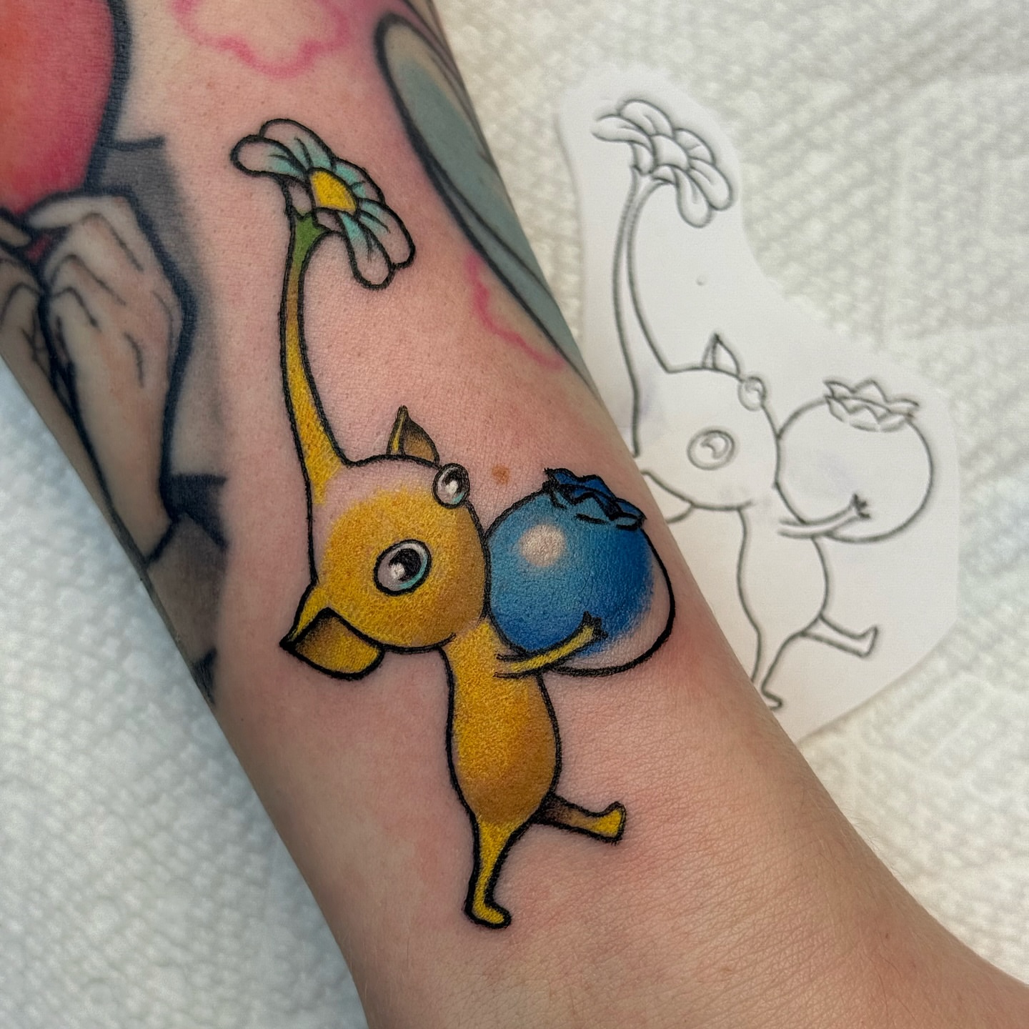Chibi cat with flower new school tattoo on the forearm by vic