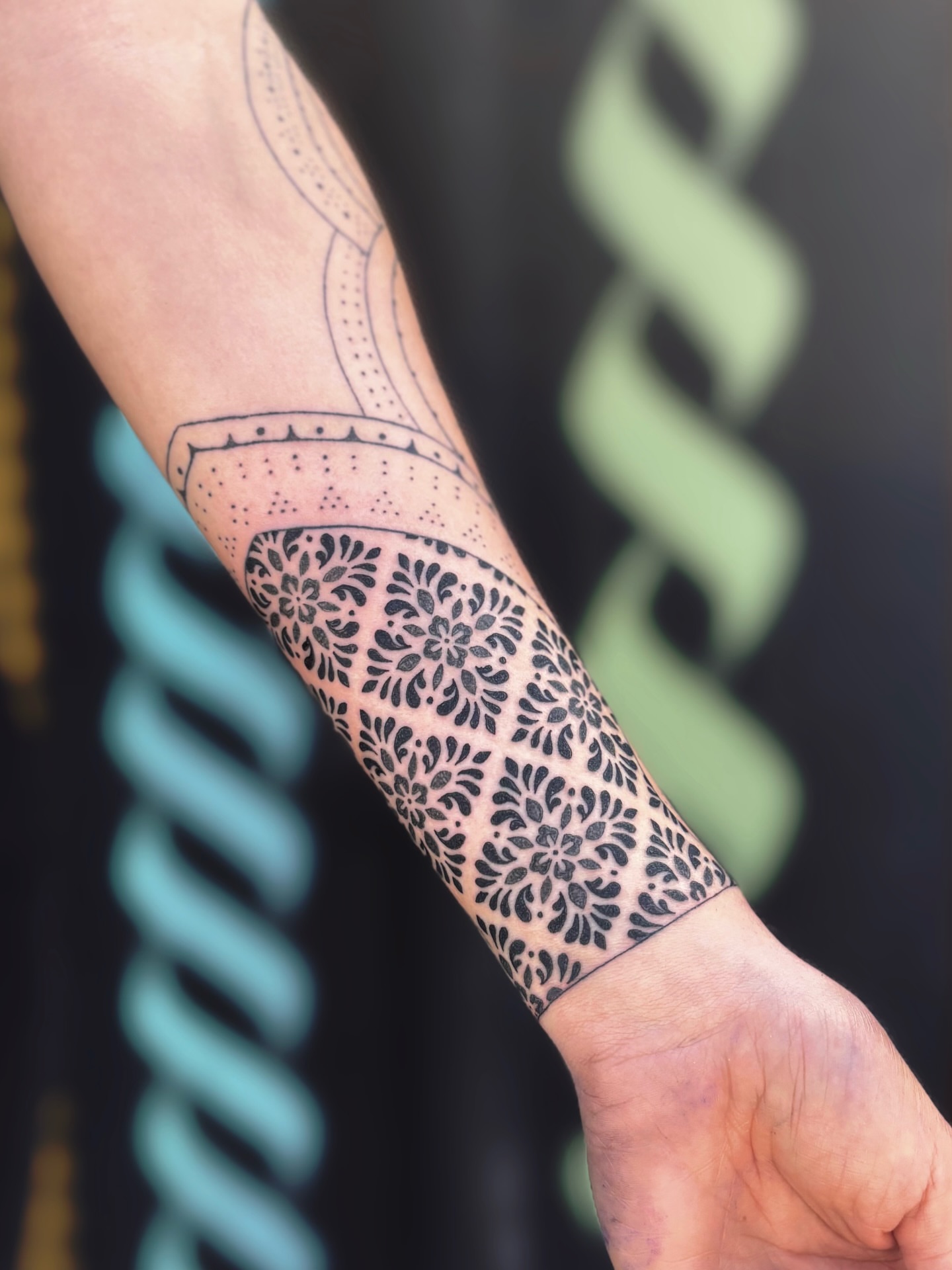 Floral pattern dotwork tattoo on the forearm by Storm Smith
