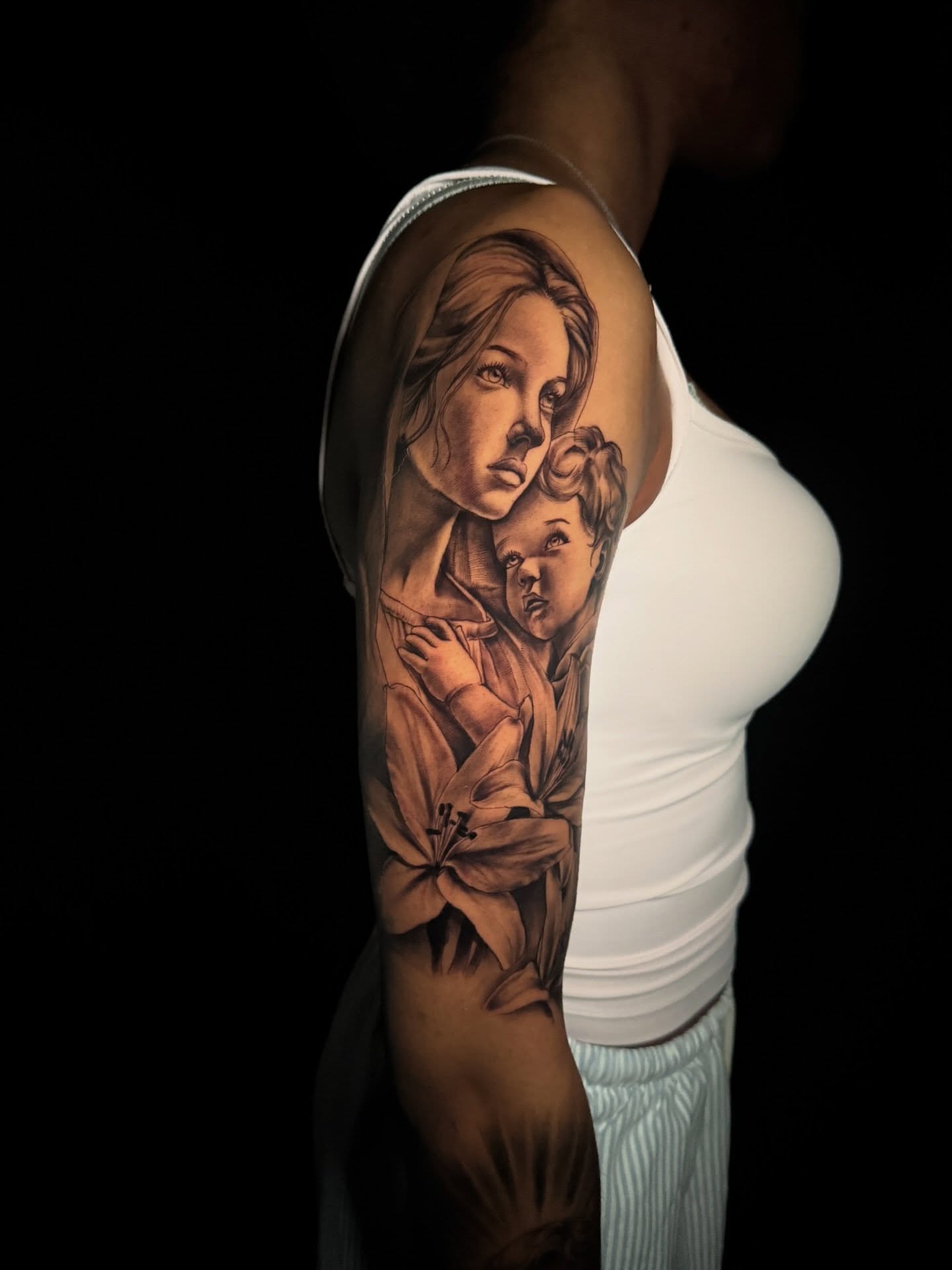 Mother and child realism tattoo on the upper arm by Atl Tattoo Artist✍🏾👨🏾‍🎨