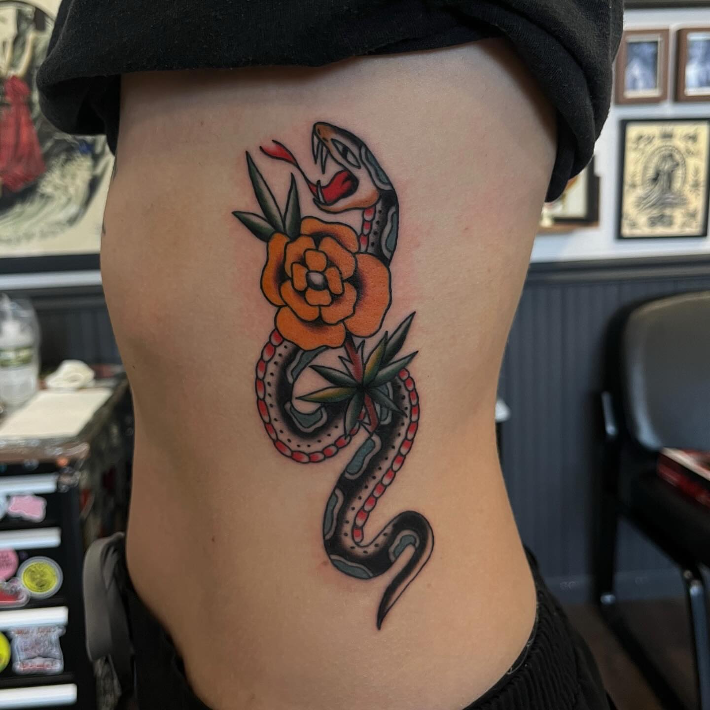 Snake and flower American traditional tattoo on the ribs by Elizabeth Summers ❨・¨⬮ Traditional Tattoo