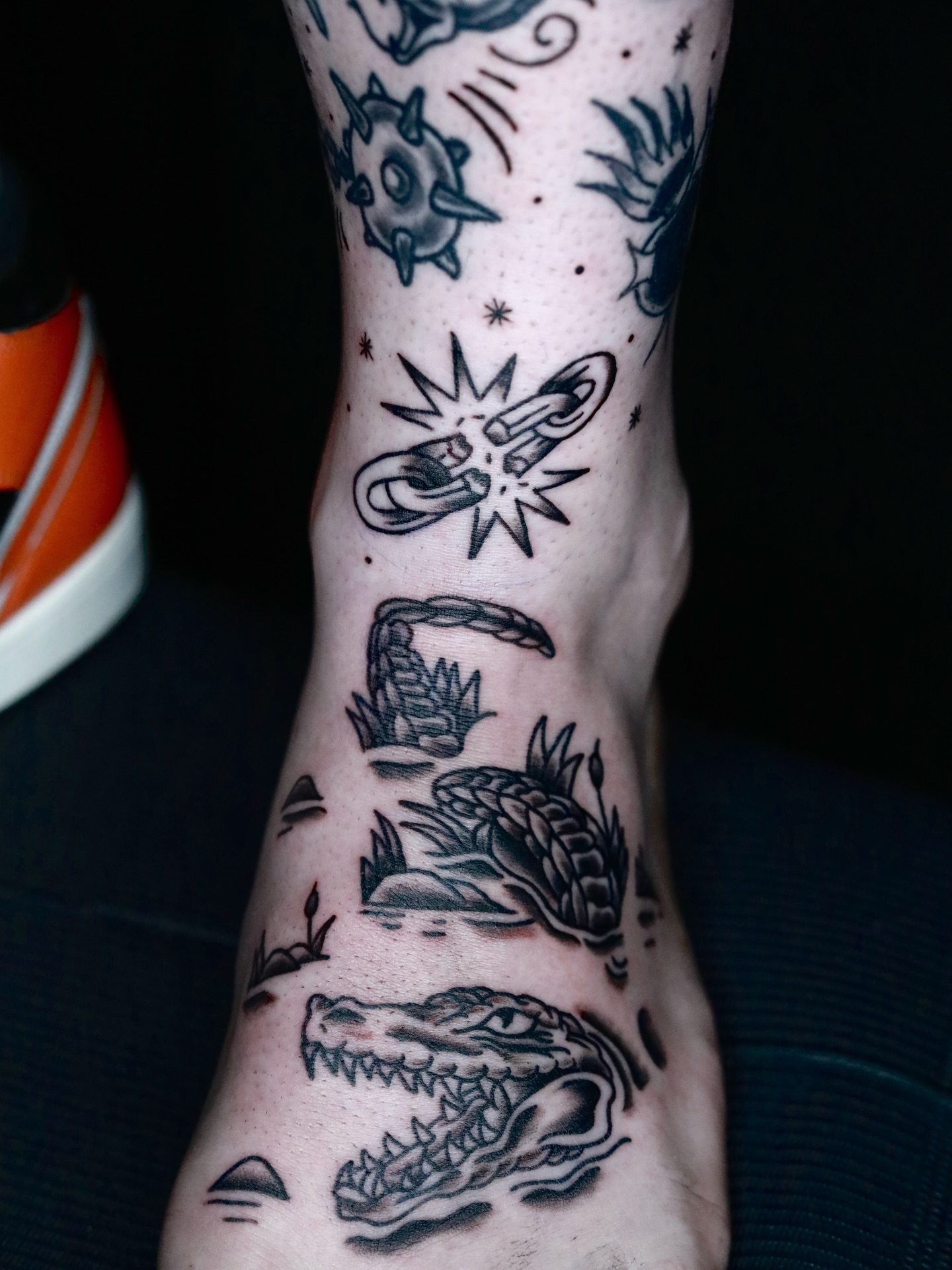 Alligator and plants black and grey tattoo on the calf by memo