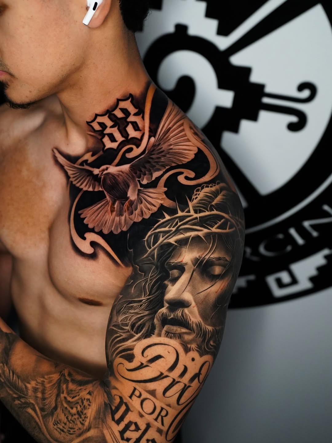 Jesus Christ and dove Chicano tattoo on the shoulder by Salvador Saenz Jr, Dallas, Texas