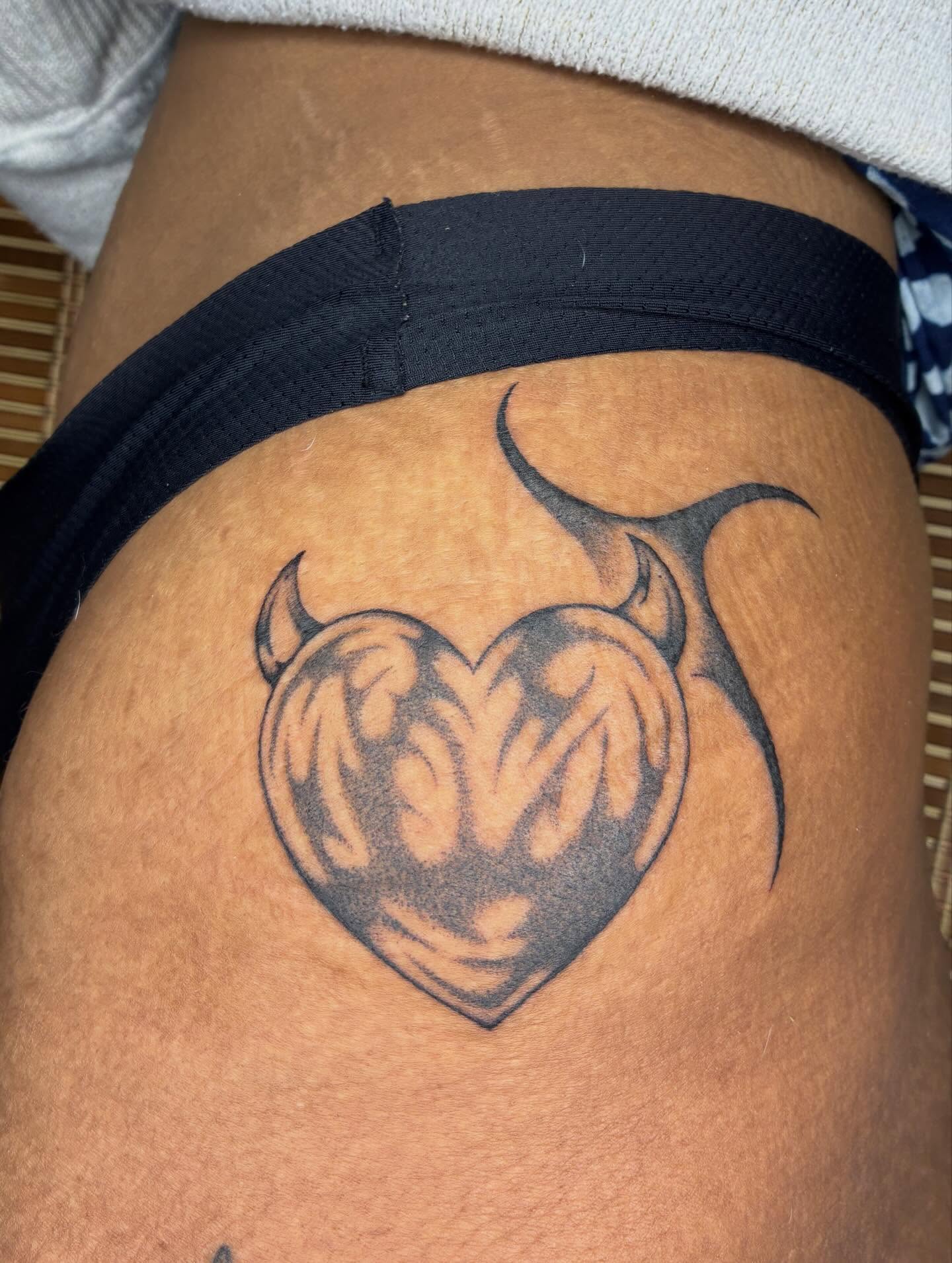 Heart with horns black and grey tattoo on the thigh by Steven Sessler, San Francisco, California