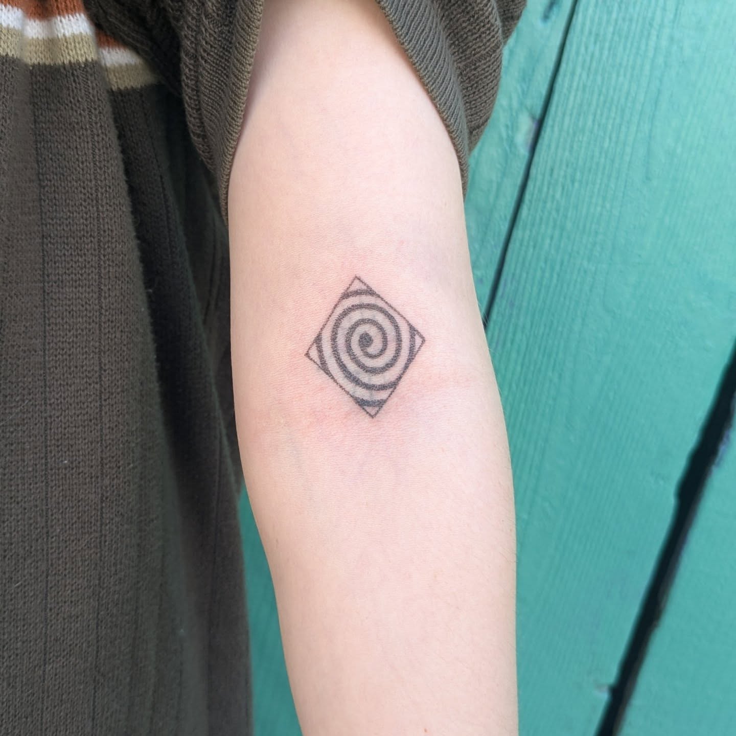 Spiral geometric tattoo on the forearm by theo, Portland, Oregon