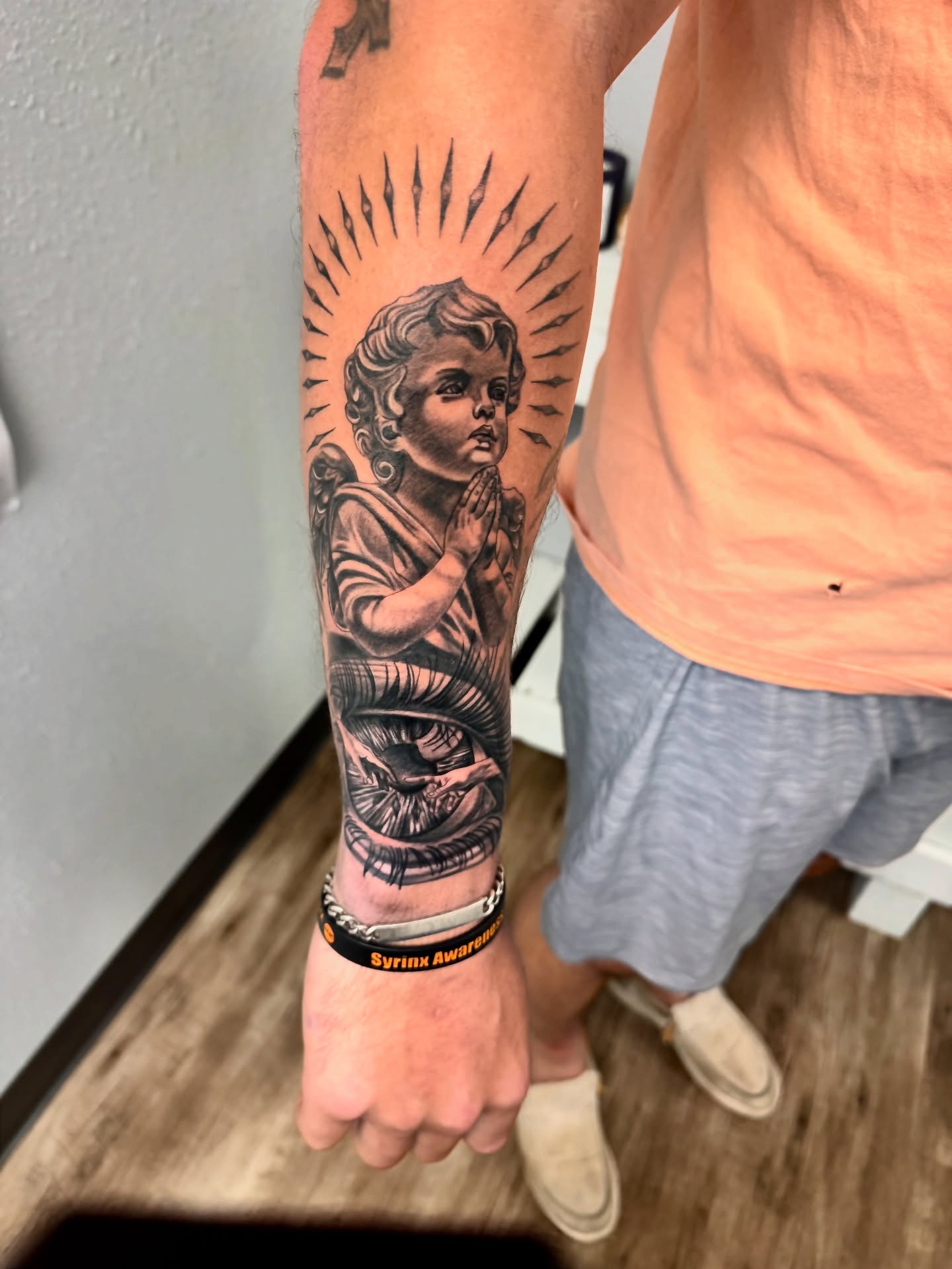 Angel praying black and grey tattoo on the forearm by Tampa tattoo artist