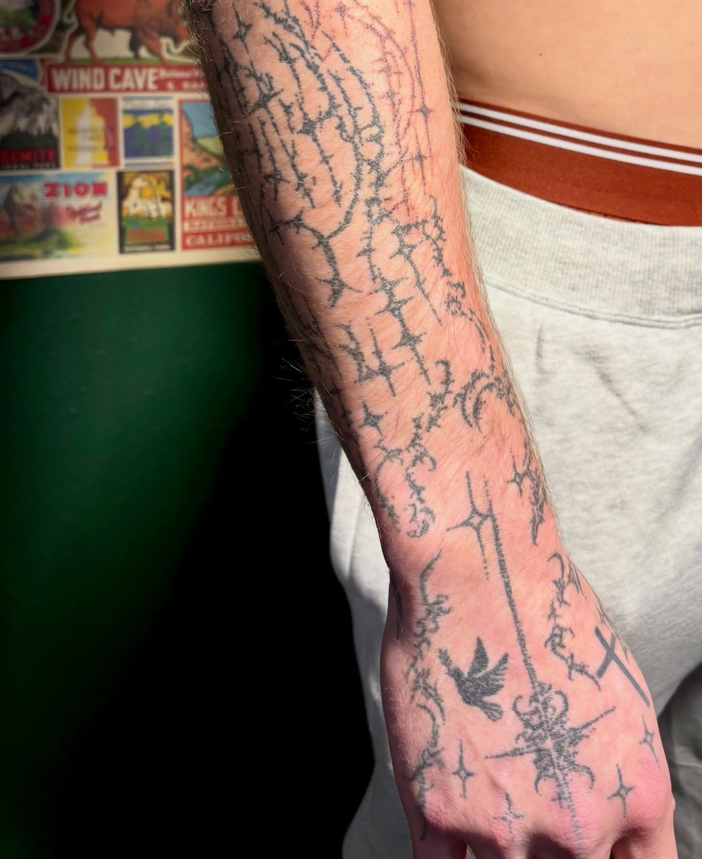 Barbed wire black and grey tattoo on the forearm by Ashley, Elk Horn, Iowa