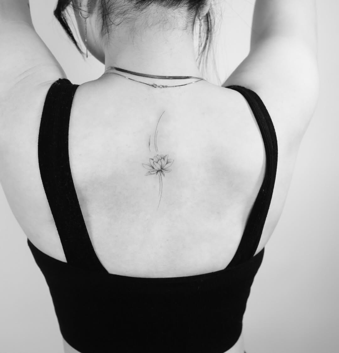 Lotus flower blackwork tattoo on the back by Fine Line, New York, New York