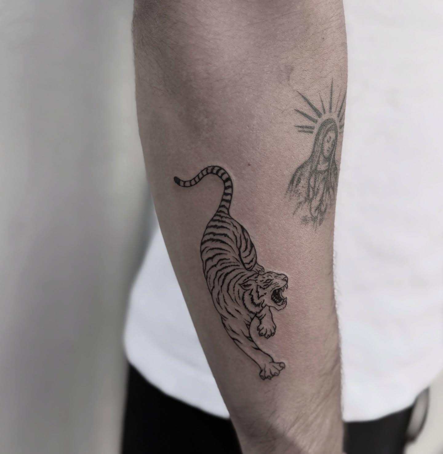 Tiger and virgin mary black and grey tattoo on the forearm by Raleigh tattoo artist, Raleigh, North Carolina