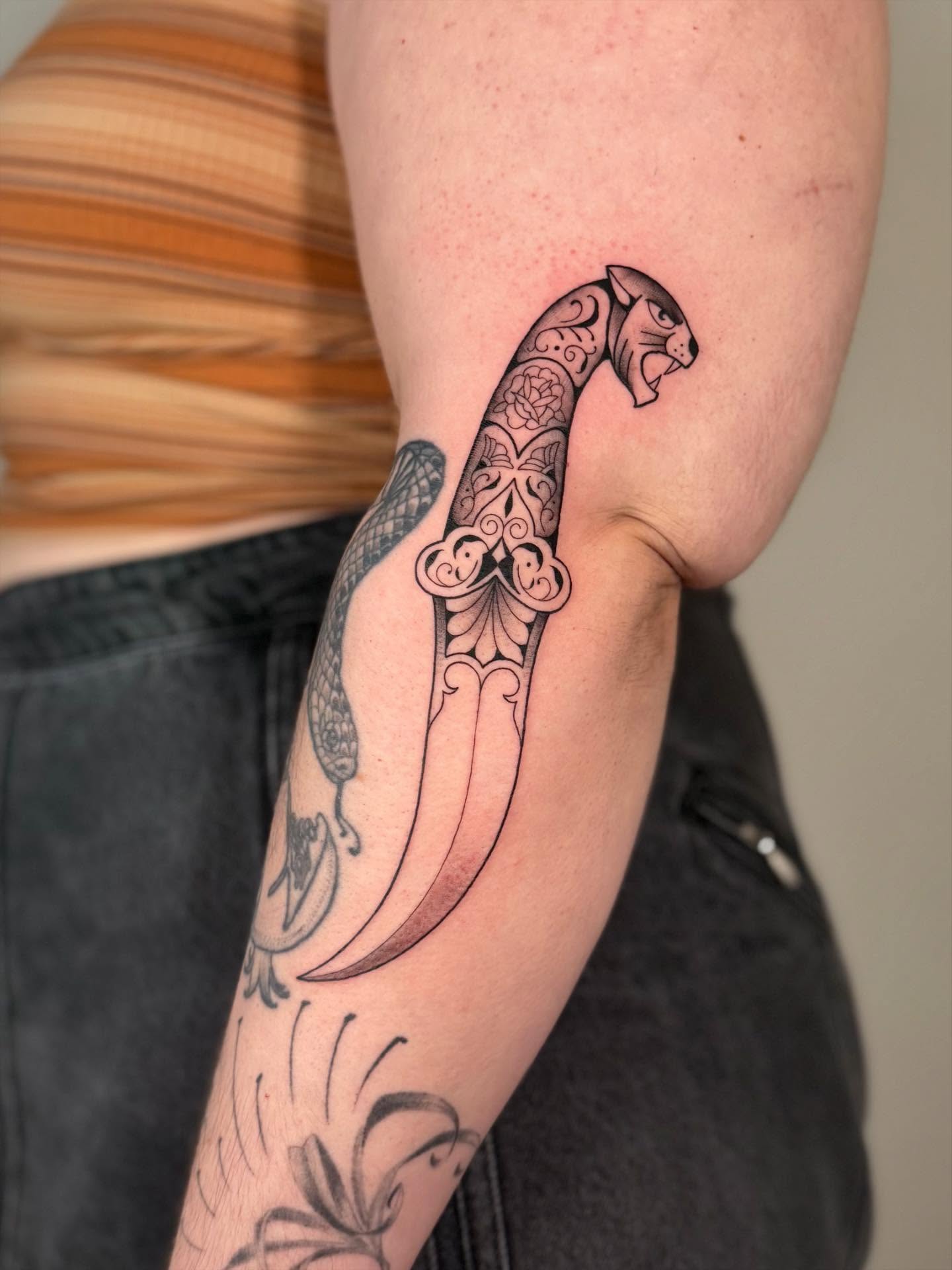 Panther black and grey tattoo on the forearm by Kail