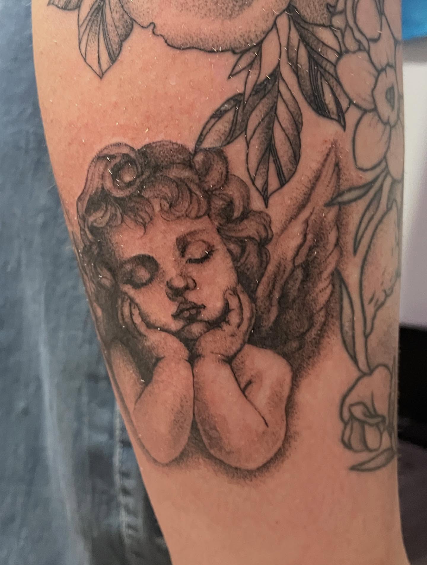 Cherub black and grey tattoo on the forearm by 🖤Jess Pereira🖤, Framingham, Massachusetts