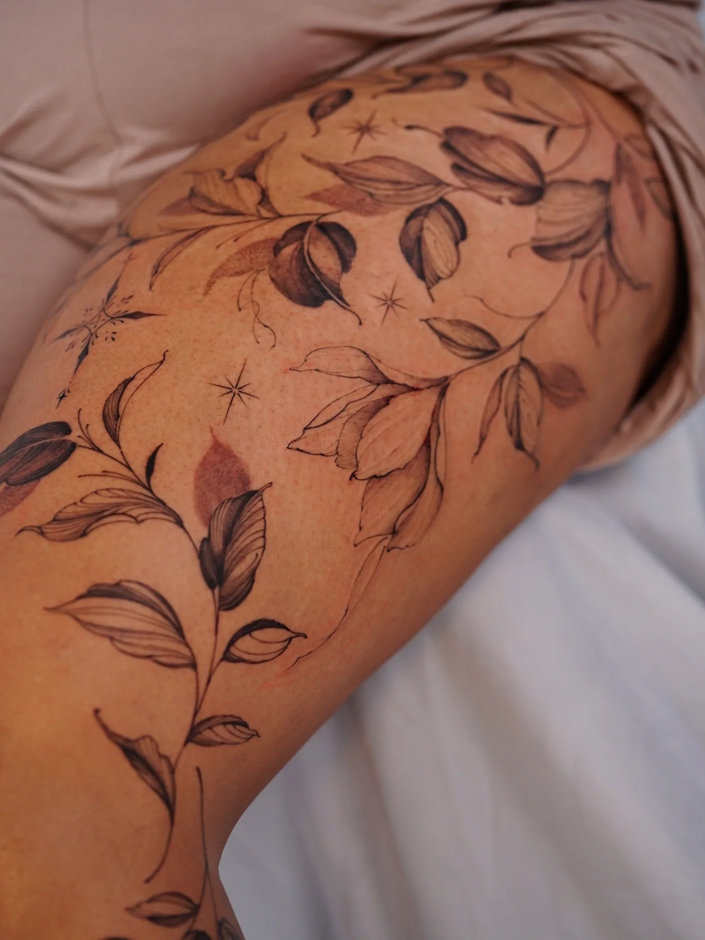 Floral design black and grey tattoo on the thigh by Vii