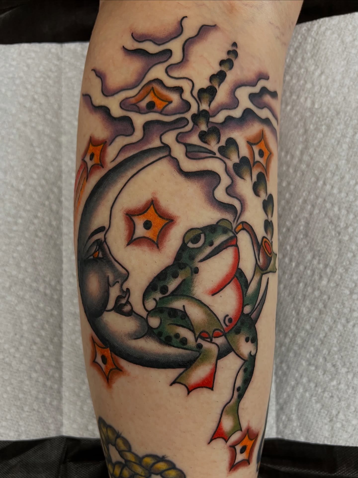 Frog and moon American traditional tattoo on the forearm by Kelsey Lane