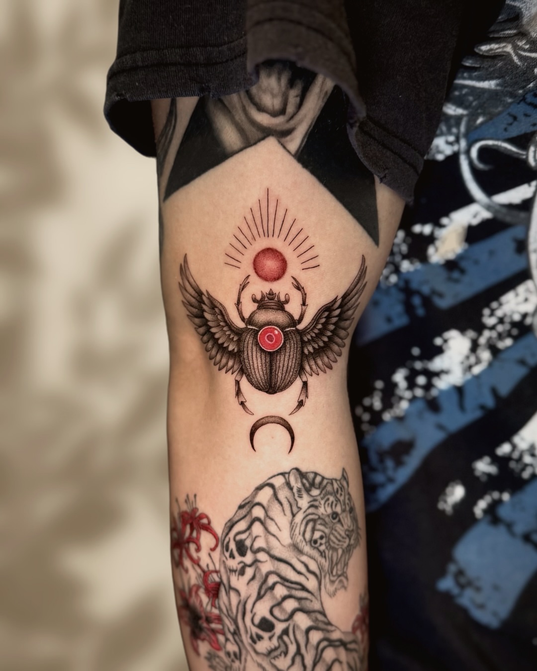 Scarab beetle geometric tattoo on the forearm by Ingrid Rojas