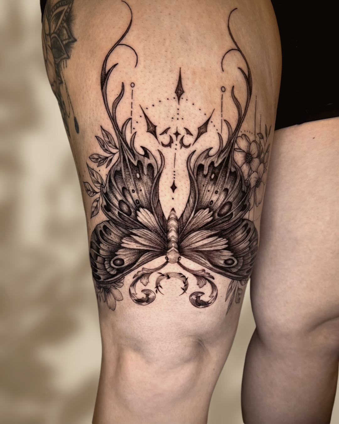 Peacock butterfly ornamental tattoo on the calf by Ingrid Rojas