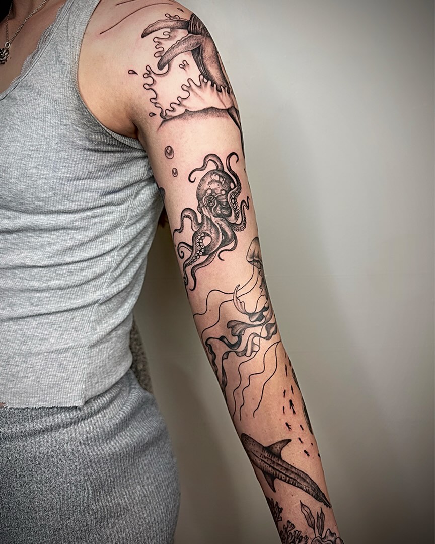 Octopus and shark black and grey tattoo on the forearm by Imani