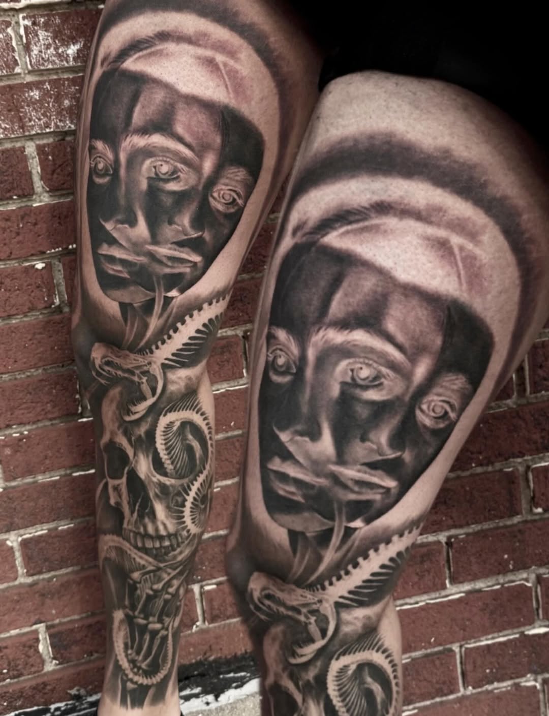 Surreal face and skull with snake surrealism tattoo on the forearm by Jeremiah Warner