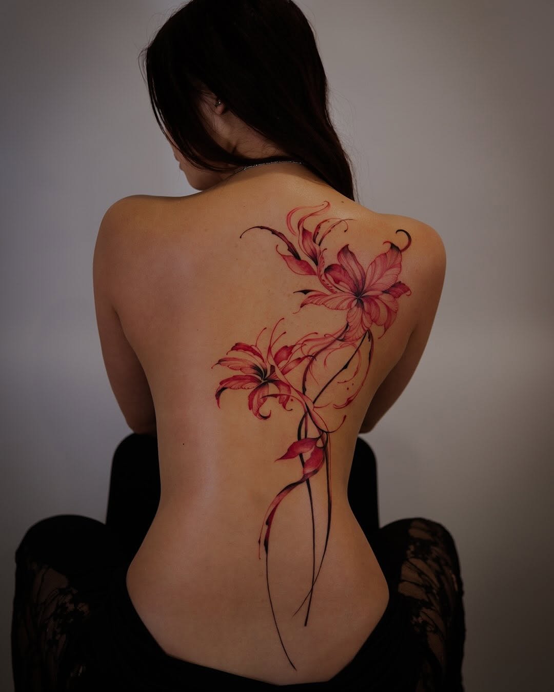 Red spider lilies blackwork tattoo on the back by Esther ✣ Fine Line Floral Tattoo Artist LA, Los Angeles, California