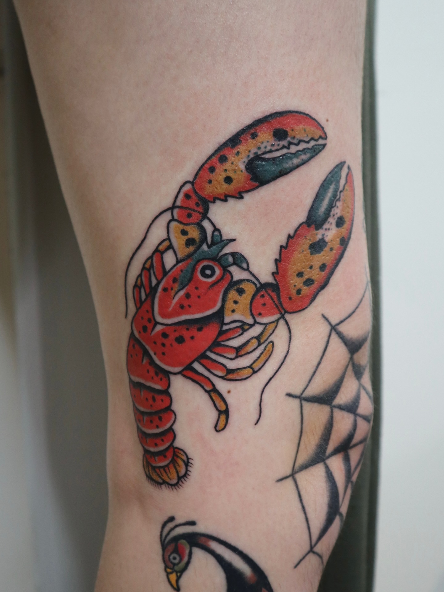 Lobster American traditional tattoo on the forearm by Kate Ortiz