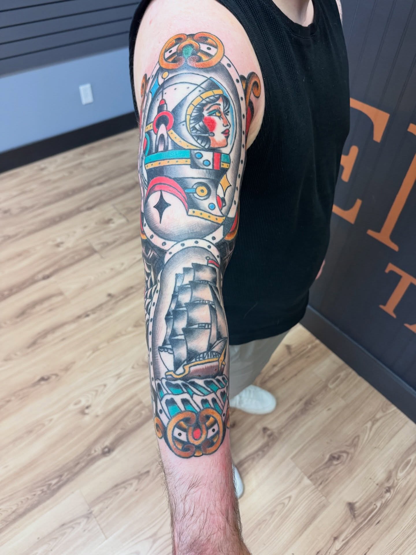 Astronaut and ship American traditional tattoo on the forearm by Justin Chapman, Des Moines, Iowa
