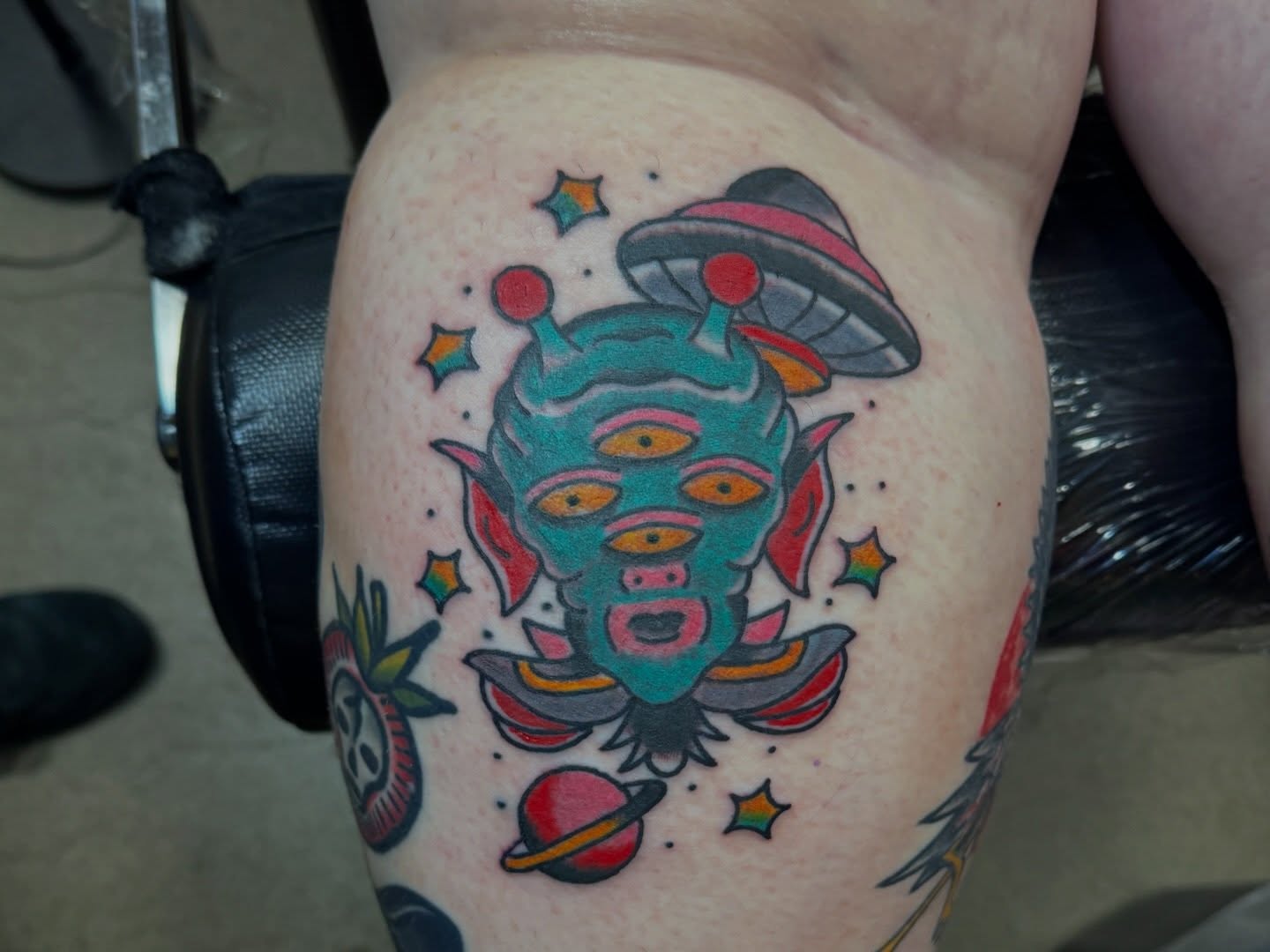 Alien head American traditional tattoo on the thigh by Justin Chapman, Des Moines, Iowa