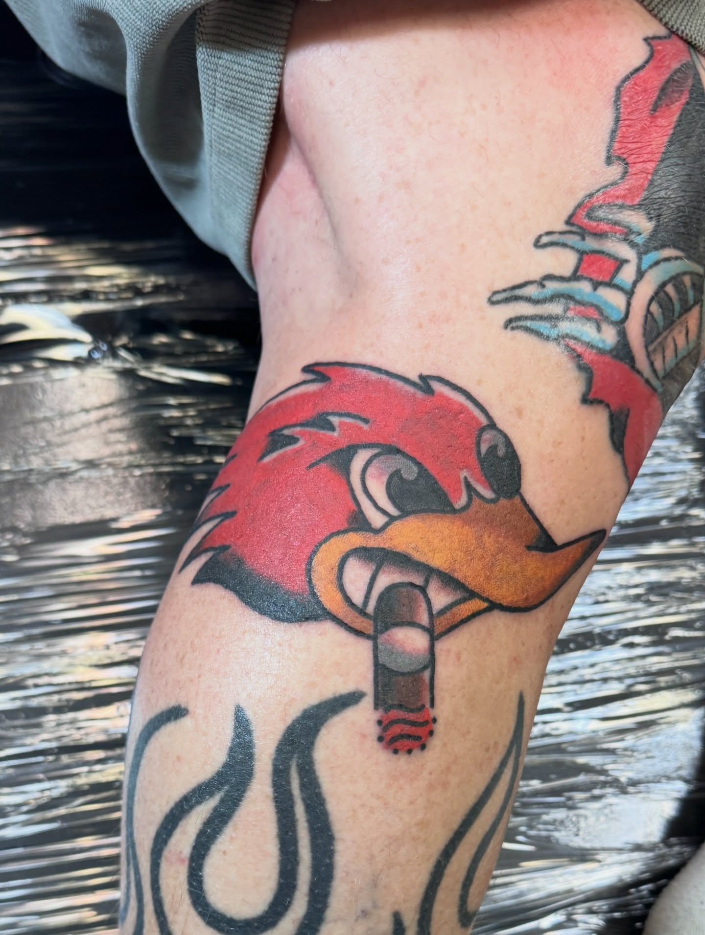Red bird American traditional tattoo on the thigh by Justin Chapman, Des Moines, Iowa