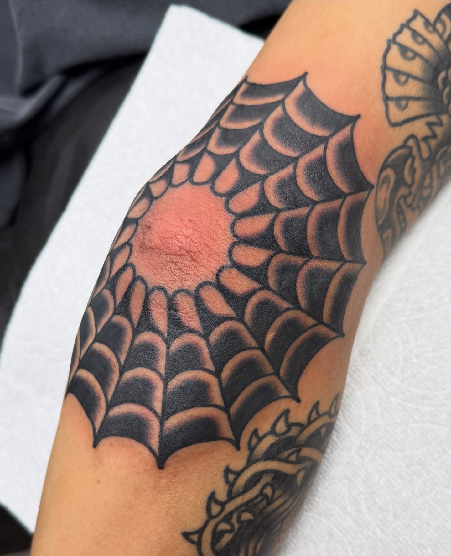 Spider web geometric tattoo on the forearm by Joey Burdette Tattoos