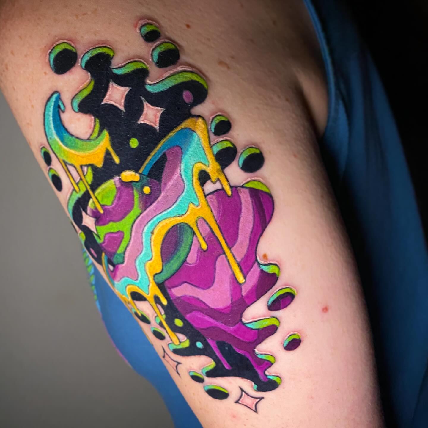 Abstract fluid design new school tattoo on the upper arm by Lindsay Hall