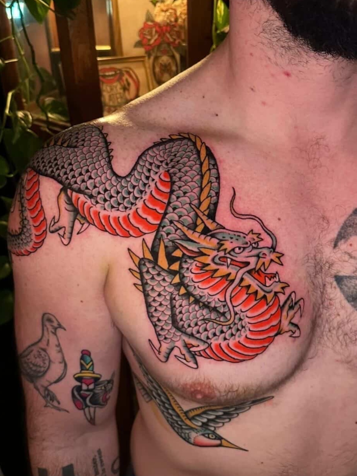 Dragon American traditional tattoo on the chest by Max Peterson