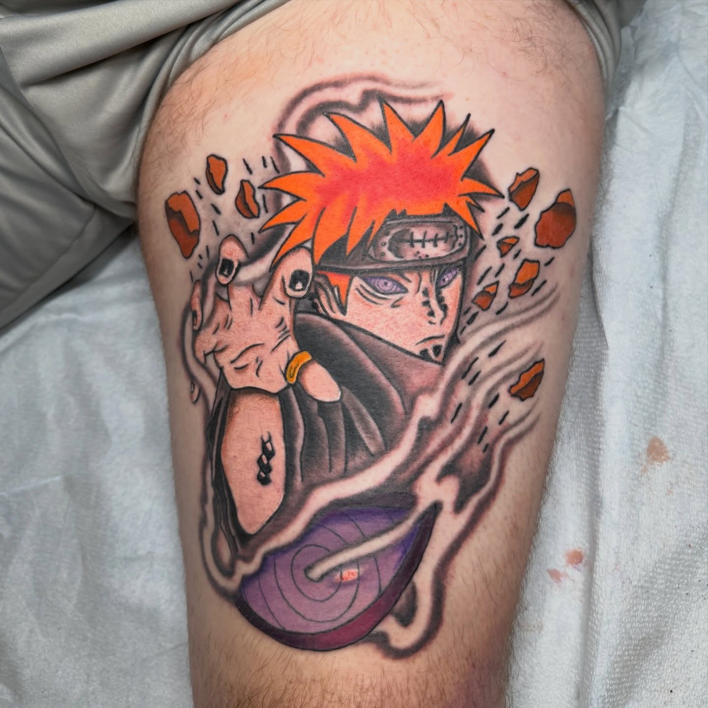 Naruto anime tattoo on the thigh by Trevor Berry