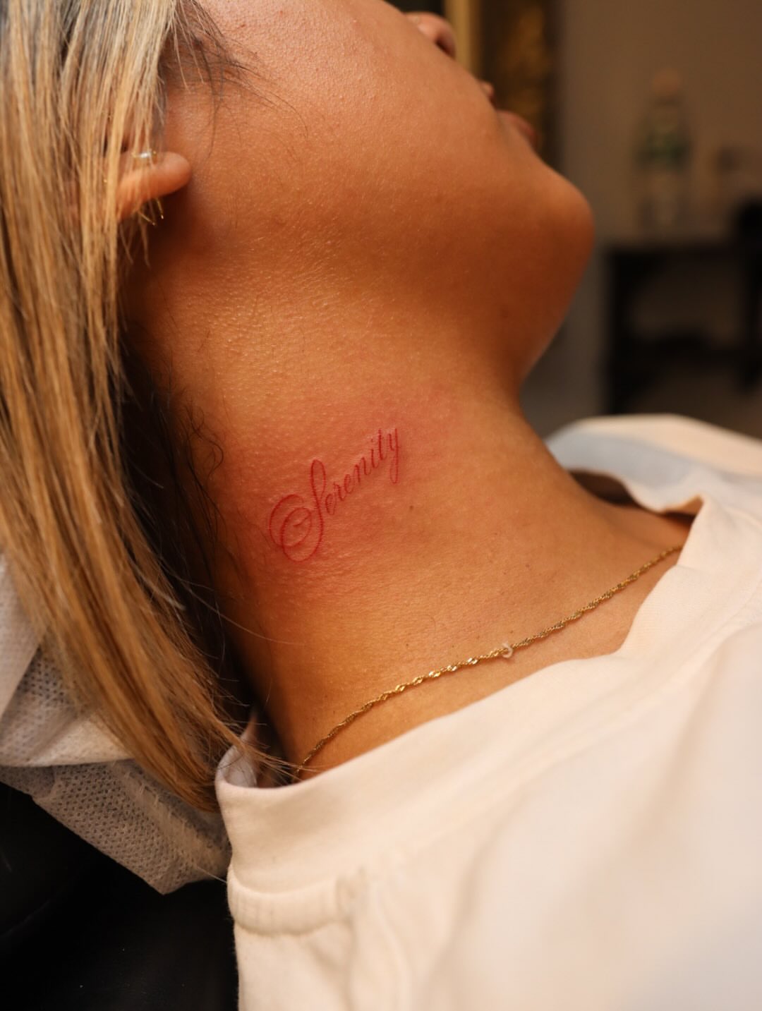 Serenity lettering script tattoo on the neck by elvis flores