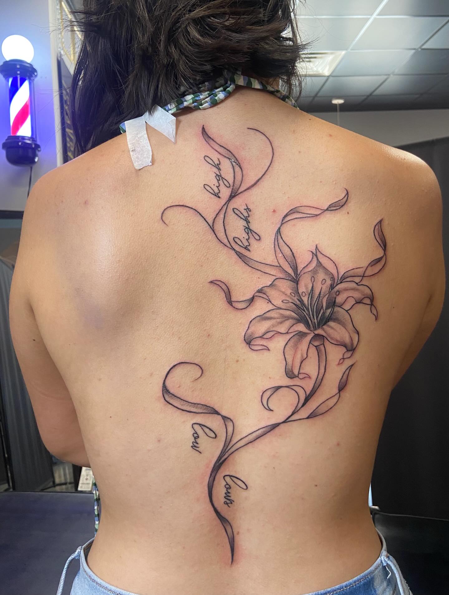 Lily black and grey tattoo on the back by Sam Hearnen, Lawrence, Kansas