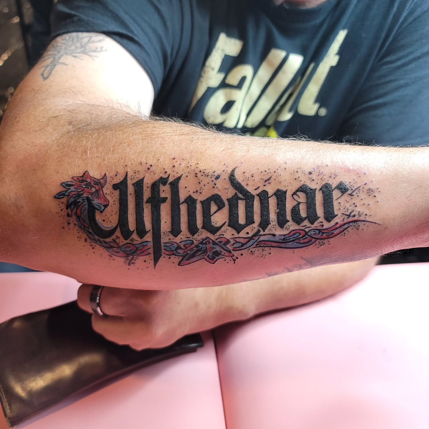 Ulfhednar lettering script tattoo on the forearm by Mary Lefeau