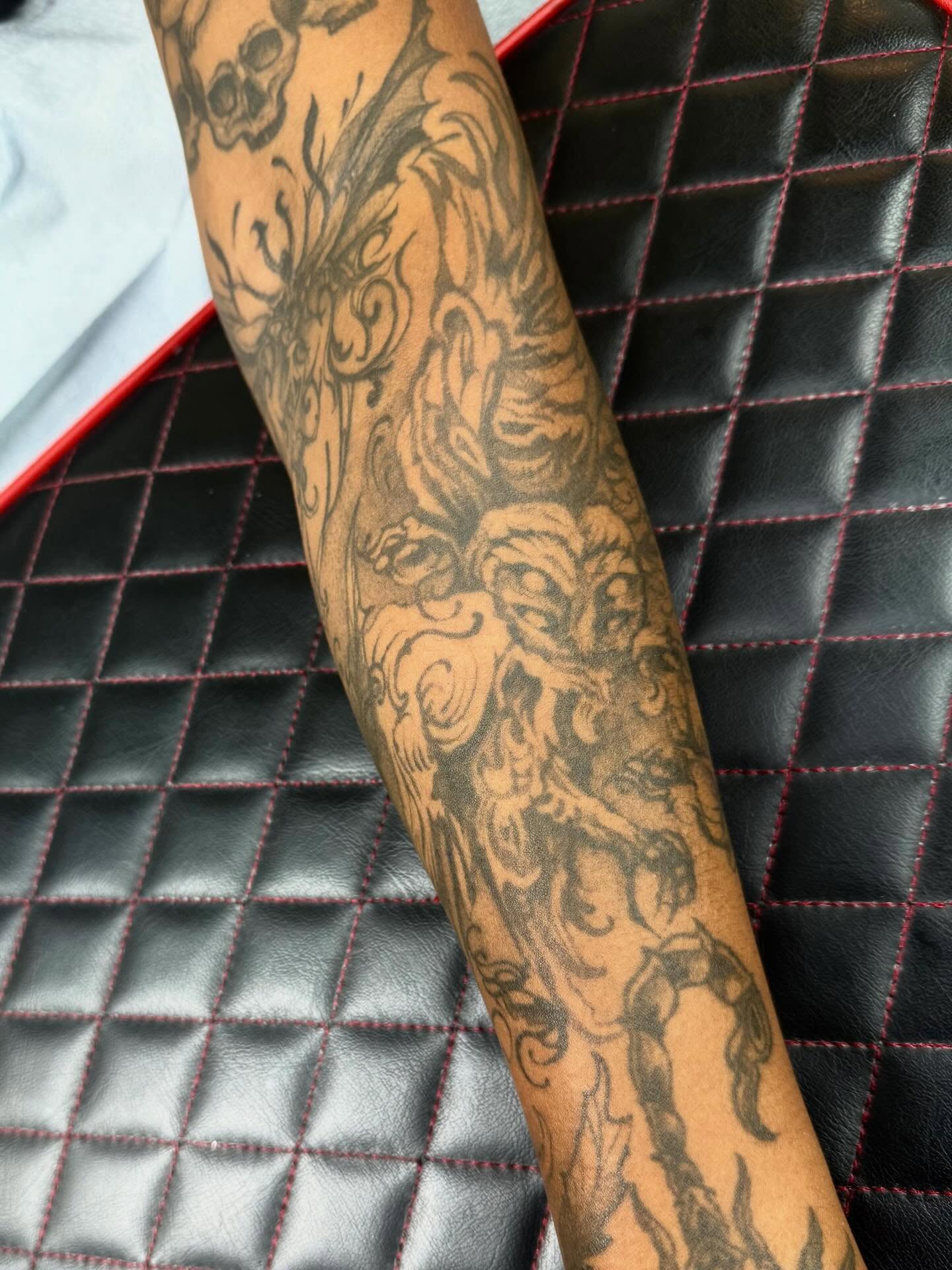 Mythical creature black and grey tattoo on the forearm by Isabella π€