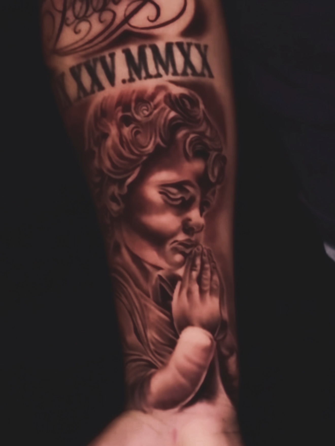Praying man realism tattoo on the forearm by Erick @ AZTEC_TATT