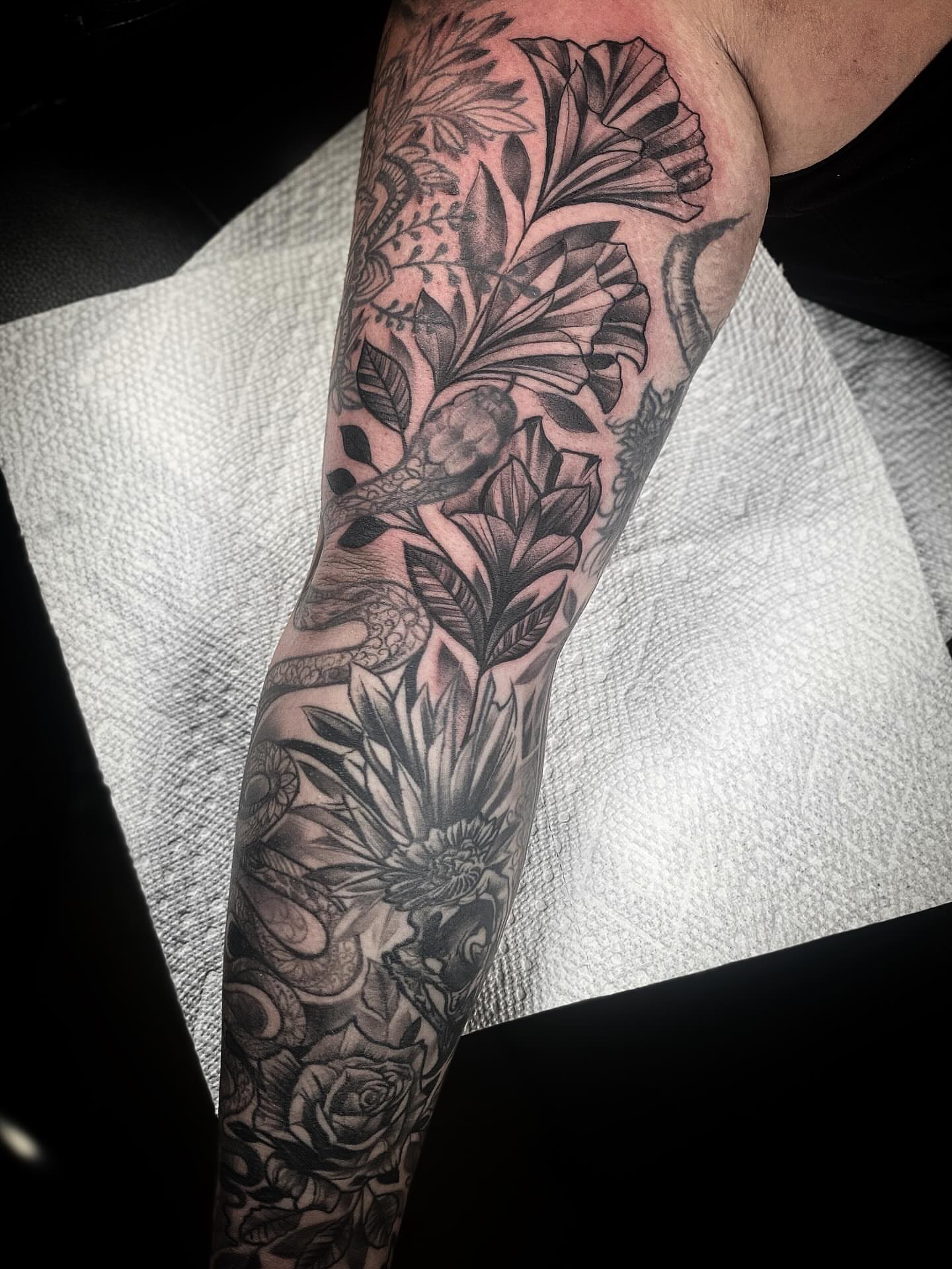 Floral bouquet realism tattoo on the forearm by Chris Klee