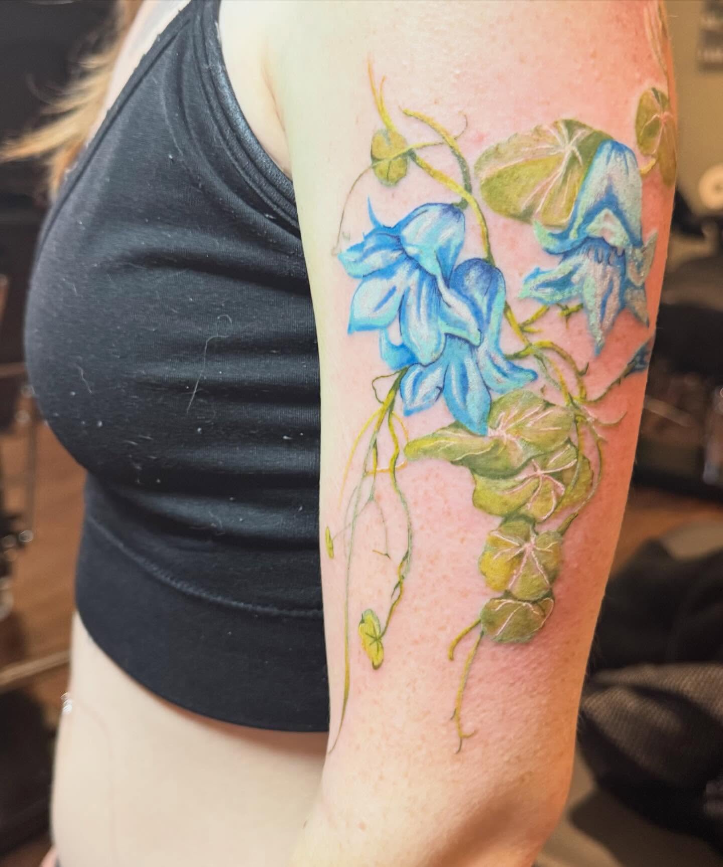 Bluebell flowers watercolor tattoo on the forearm by Cohen