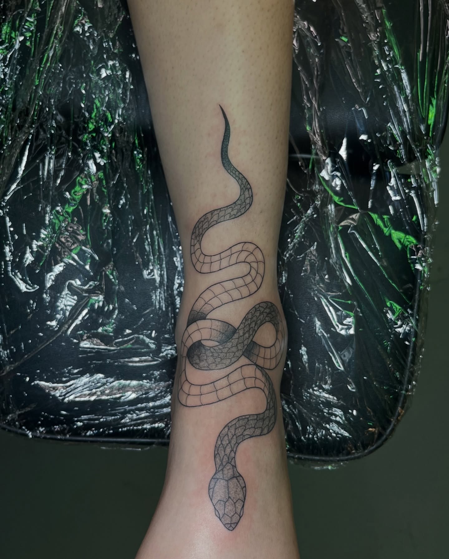 Snake black and grey tattoo on the forearm by Daniela