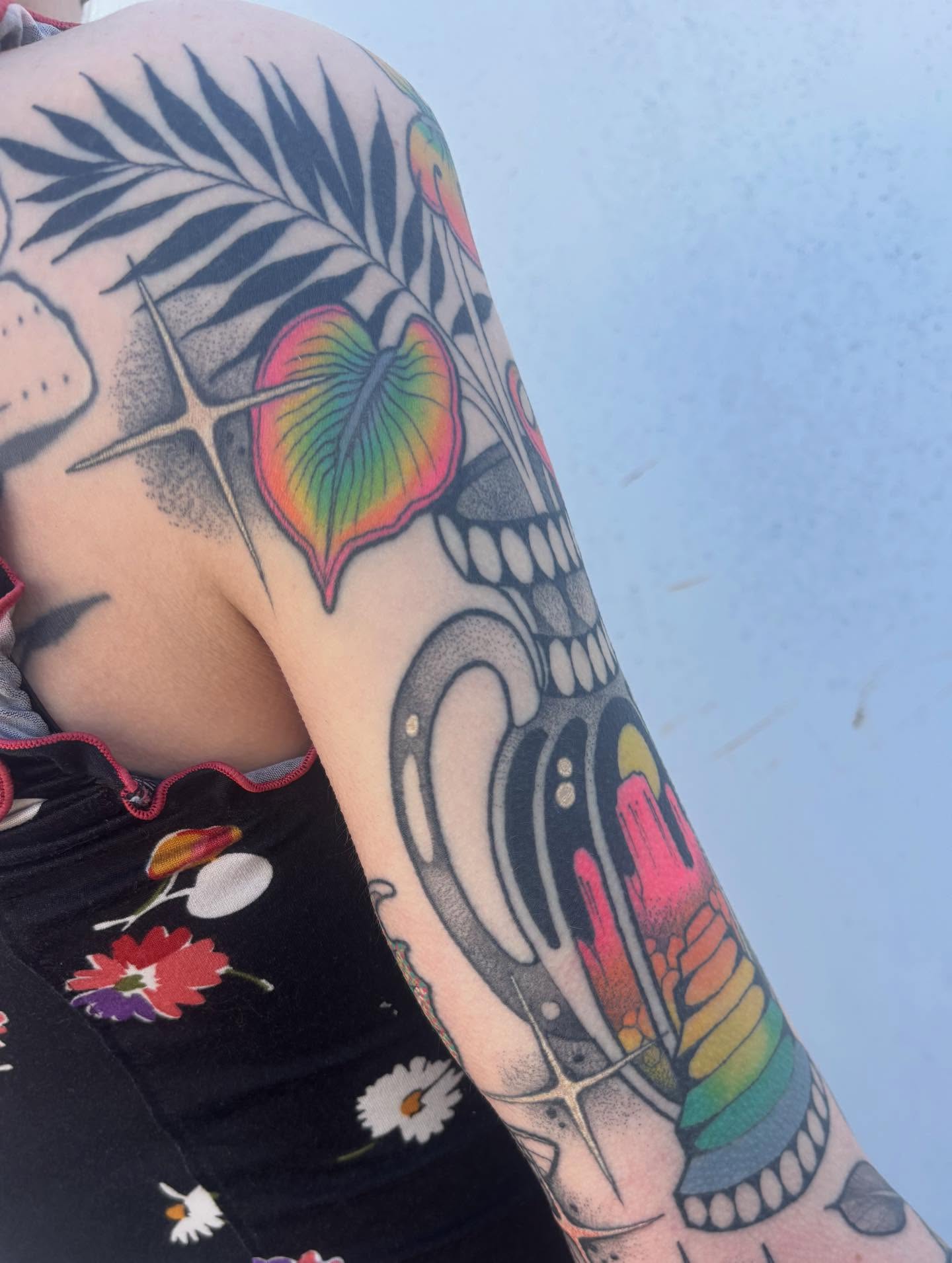 Skull with tropical leaf American traditional tattoo on the forearm by Carly Zehring