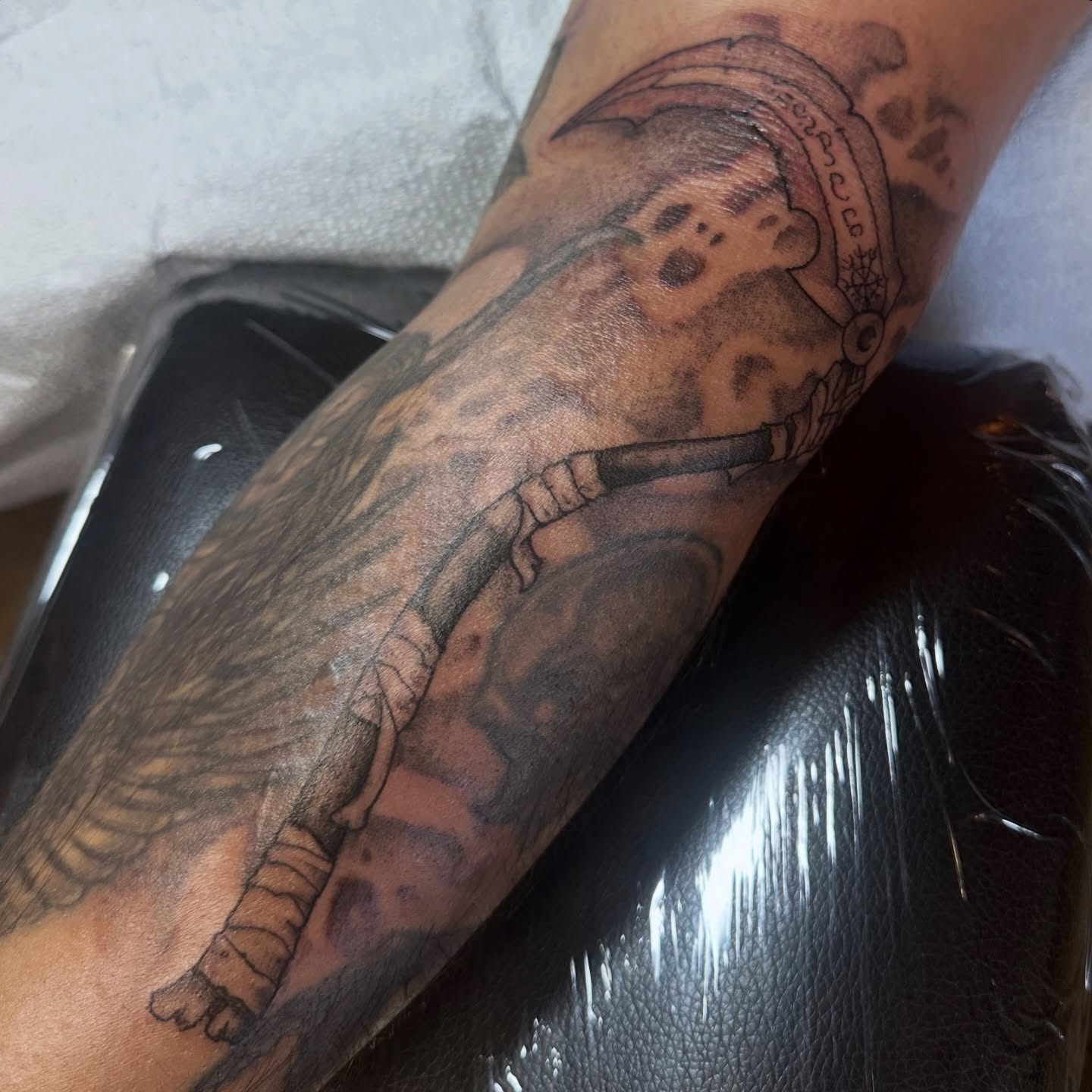 Gun and wings black and grey tattoo on the forearm by Luisa Gonzalez, Austin, Texas