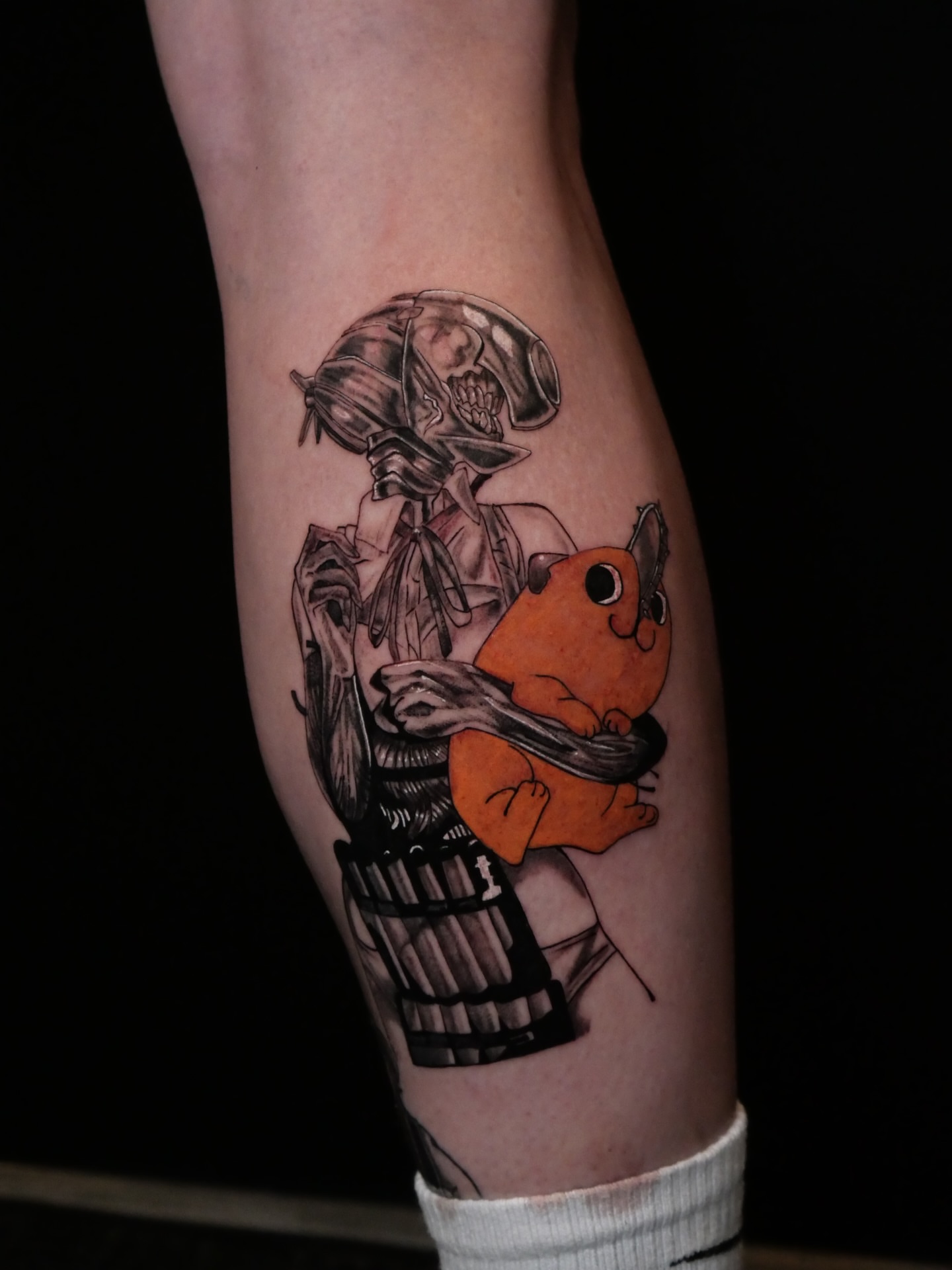 Robot and orange creature dark realism tattoo on the forearm by Sloppy