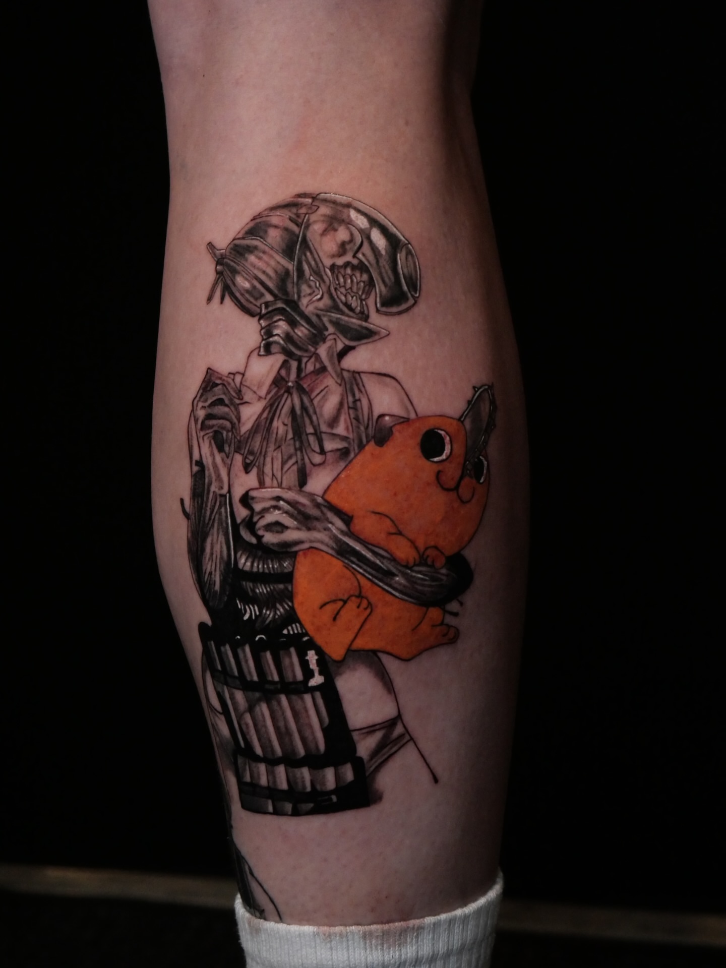 Cyborg hugging Charmander anime tattoo on the forearm by Sloppy