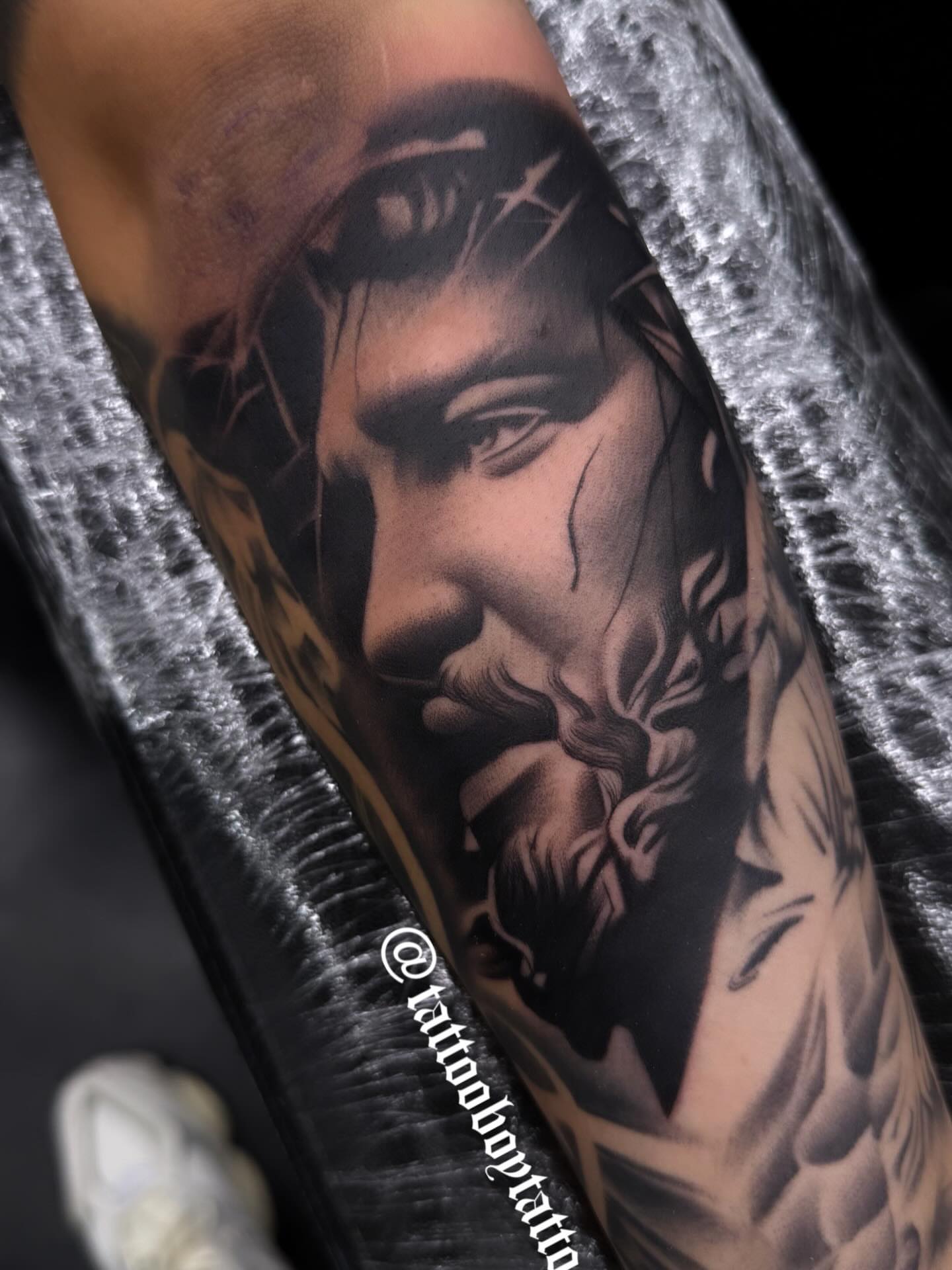Religious figure realism tattoo on the forearm by TattooBoyTattoos