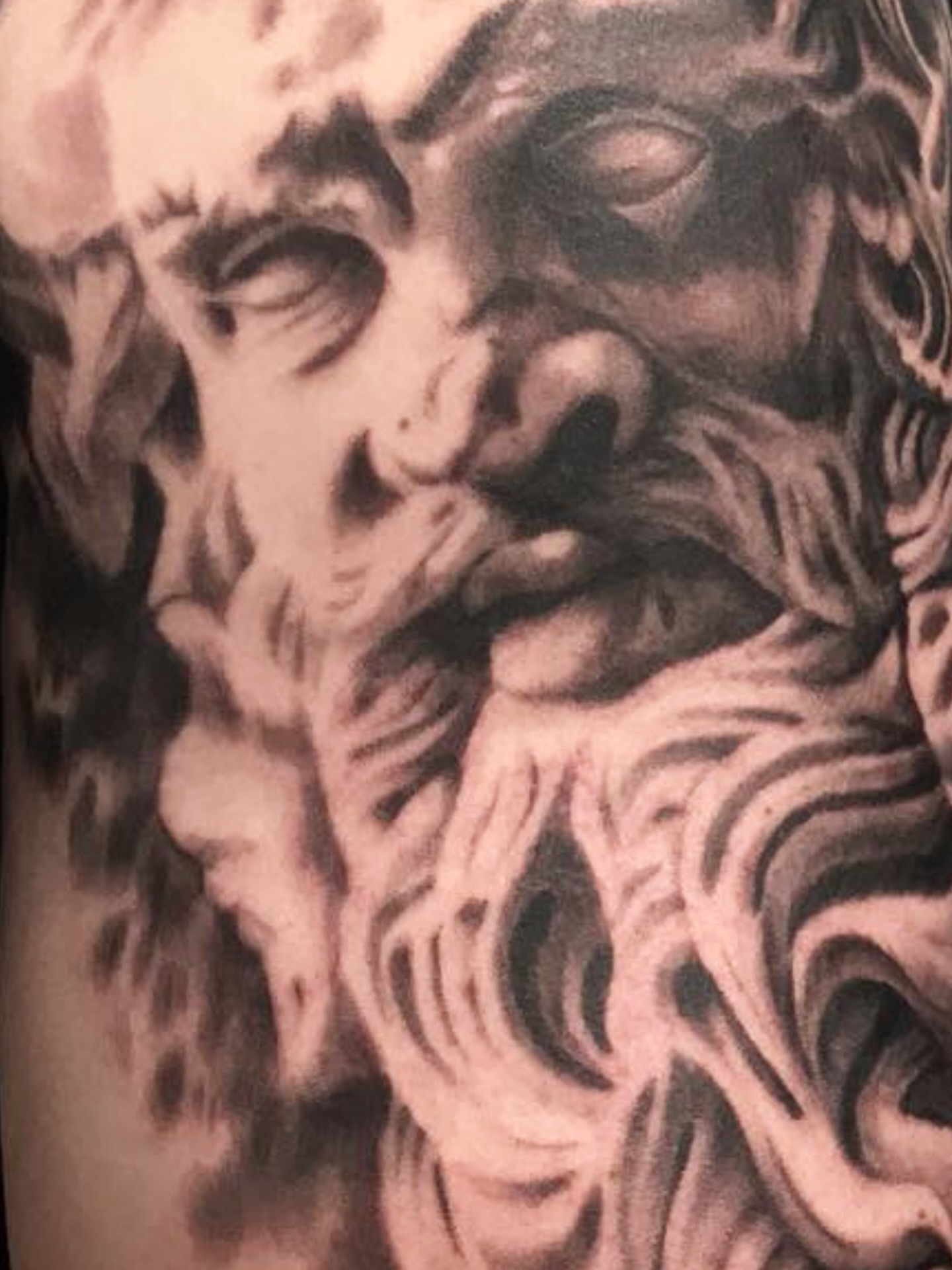 Bearded man black and grey tattoo on the forearm by Jason Oz, Denver, Colorado