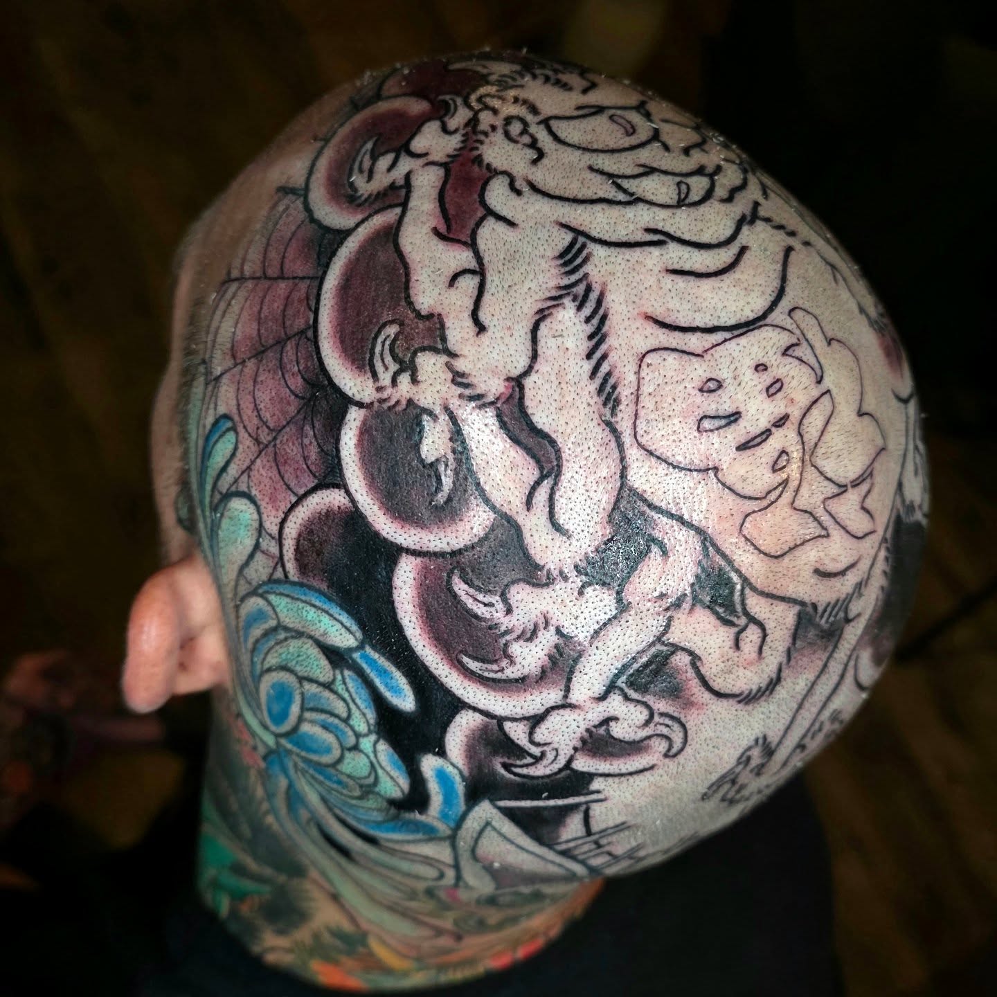 Mythical creature dotwork tattoo on the head by Frank Simanton