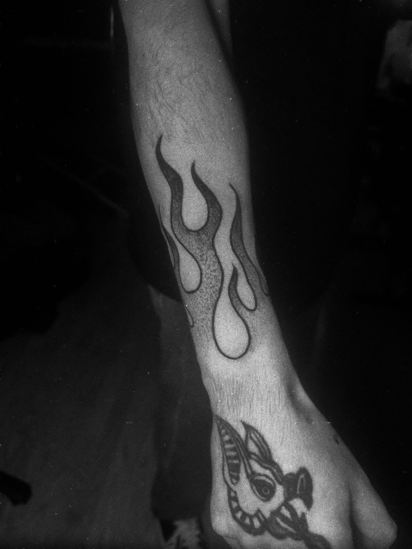 Flame black and grey tattoo on the forearm by Javierr Jimenezz