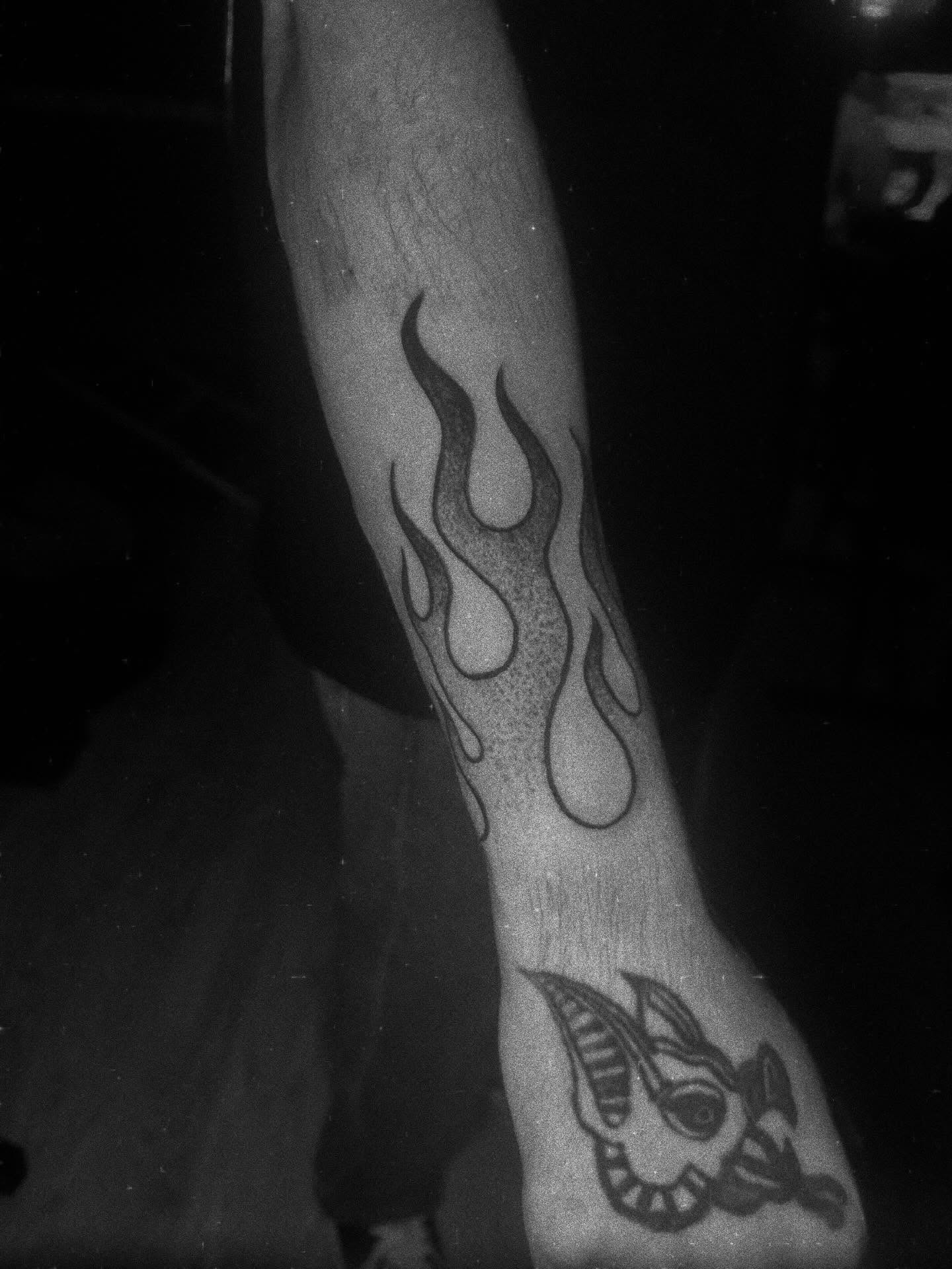 Flame black and grey tattoo on the forearm by Javierr Jimenezz