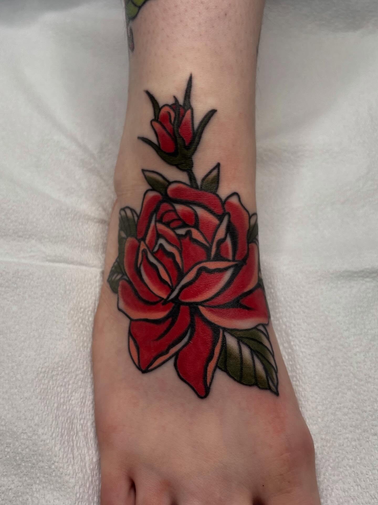 Red rose American traditional tattoo on the foot by Lily, Eugene, Oregon